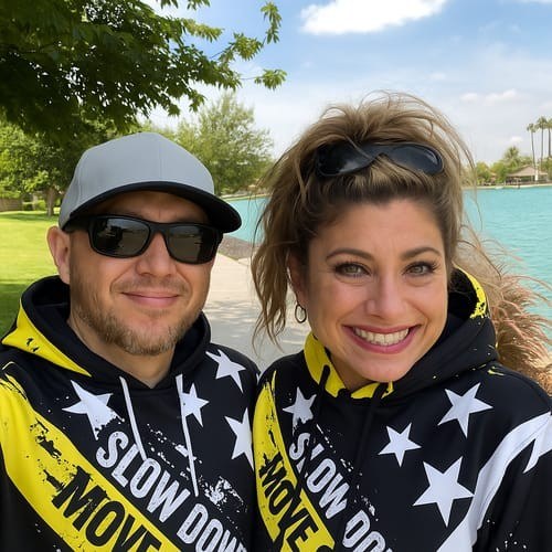 Couple in matching Slow Down Move Over hoodies