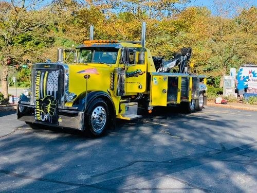 Yellow heavy-duty wrecker parked on a sunny day