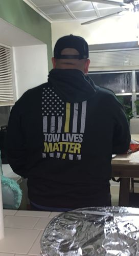 Customer in Tow Lives Matter apparel, seen from behind