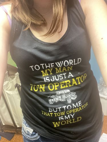 Customer wearing a 'my man is just a tow operator' tank top